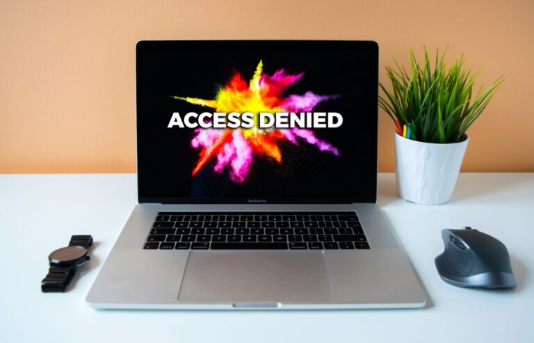 laptop with screen that reads "Access Denied"