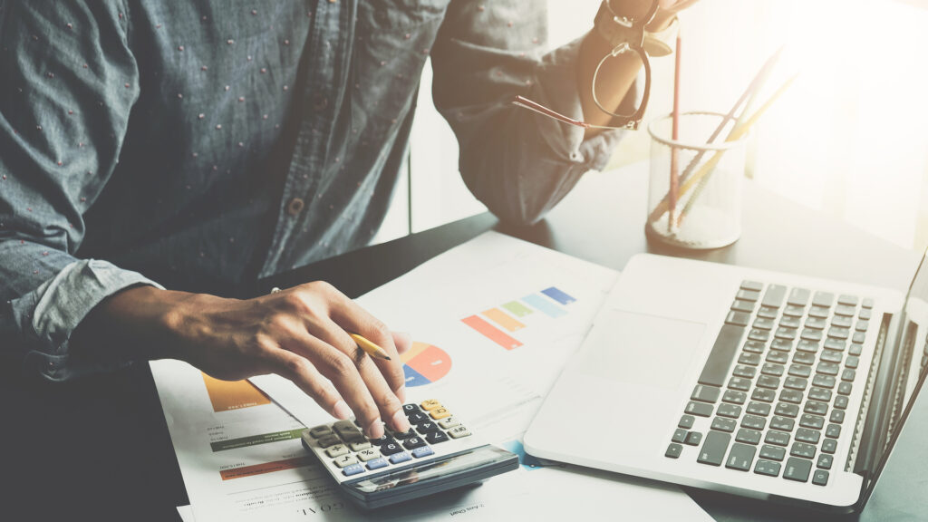 man calculating business expenses
