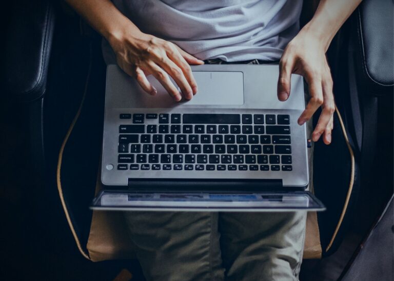 Analyst using a laptop for research representative of SMI Aware analysts finding and preserving social media evidence