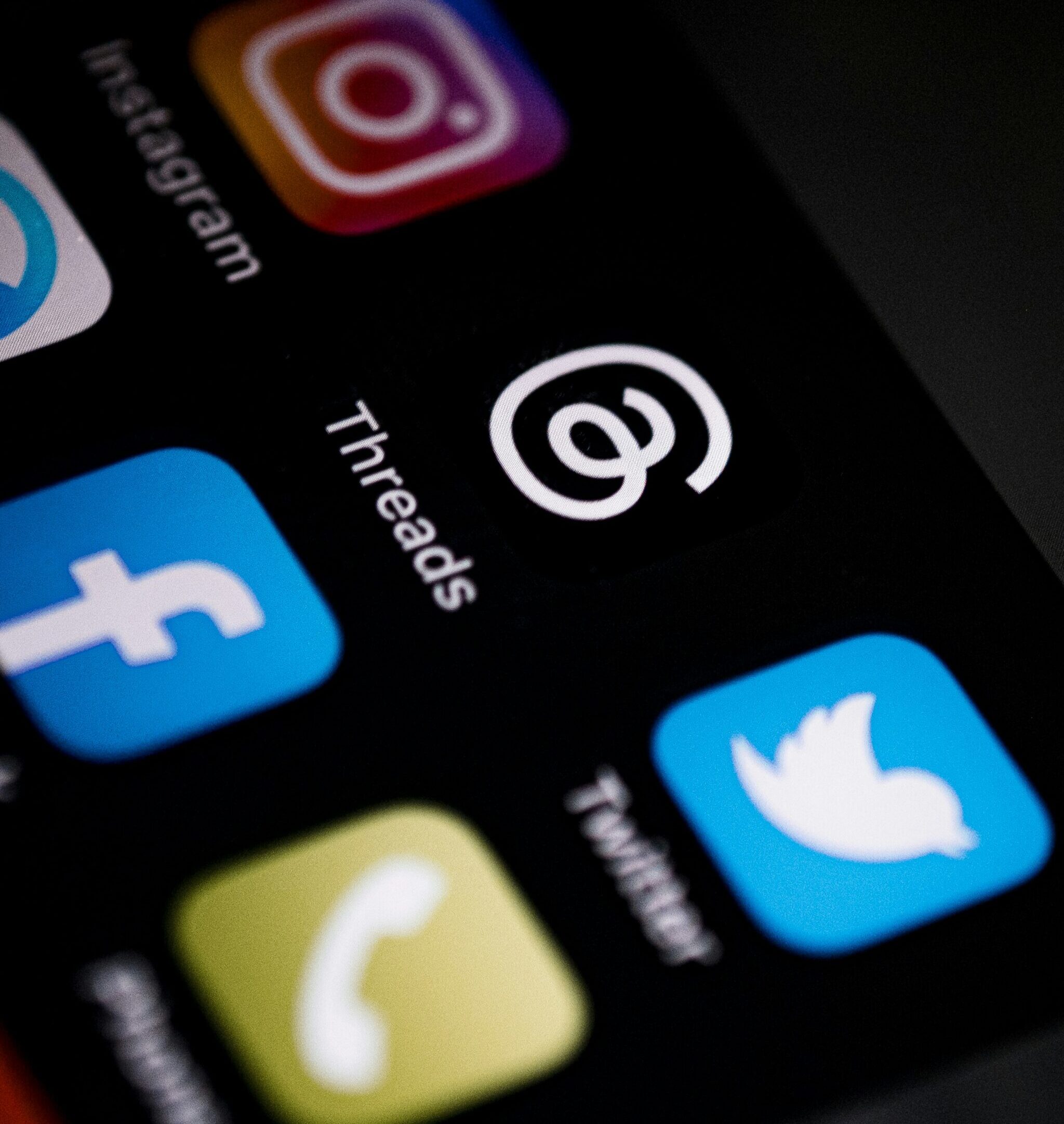 Social Media applications including Instagram, Facebook, Threads, and Twitter on a cell phone screen