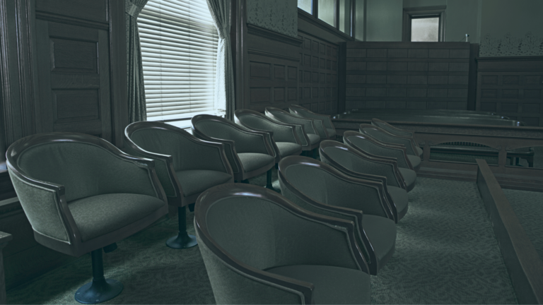 12 empty jury chairs in a courtroom